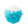 A spherical Big Blue bath bomb with a crisp white top and a vibrant light blue body. The textured surface is flecked with small bits of seaweed.
