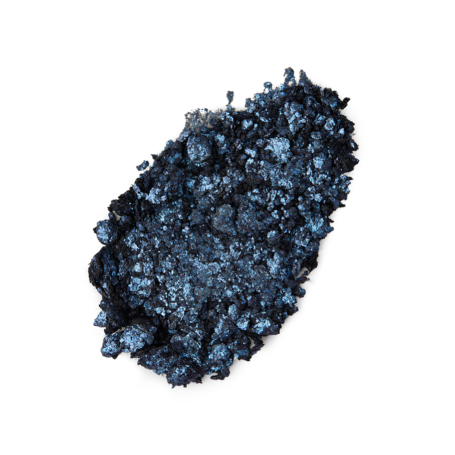 Nebula Glitter Crumble. A neatly smudged swatch of crumbly, shimmering, midnight-blue, metallic eyeshadow.
